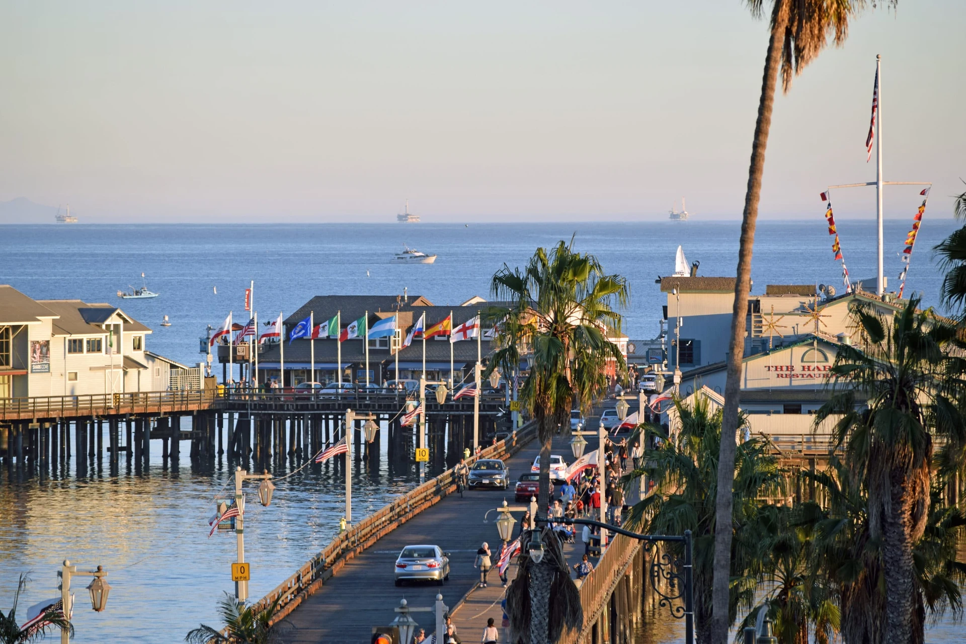 An aerial shot of cars driving down the Stearns Wharf pier in Santa Barbara.