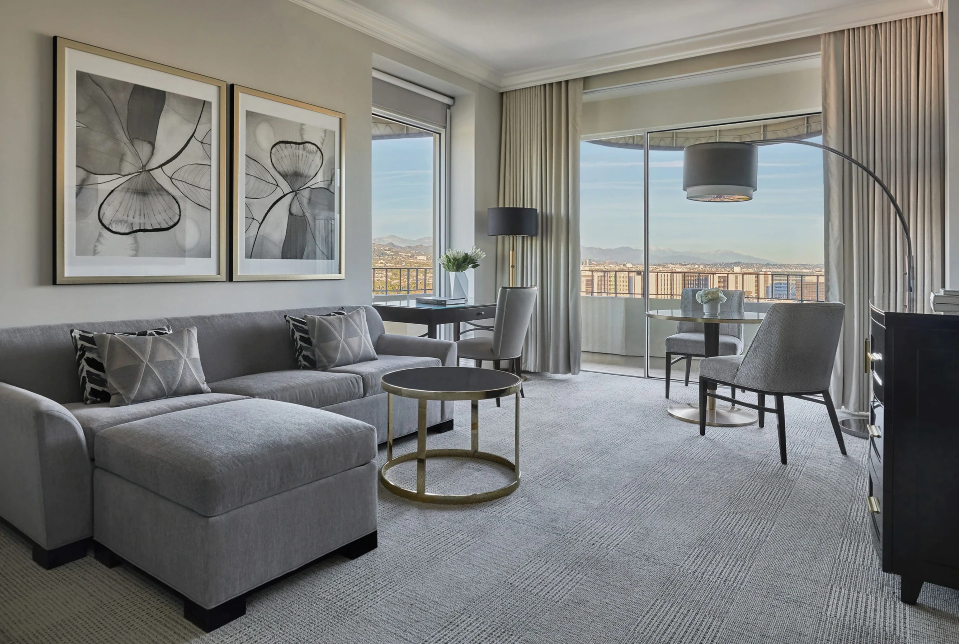 Neutral and grey tones with black and gold accents in the Luxury Suite living room.