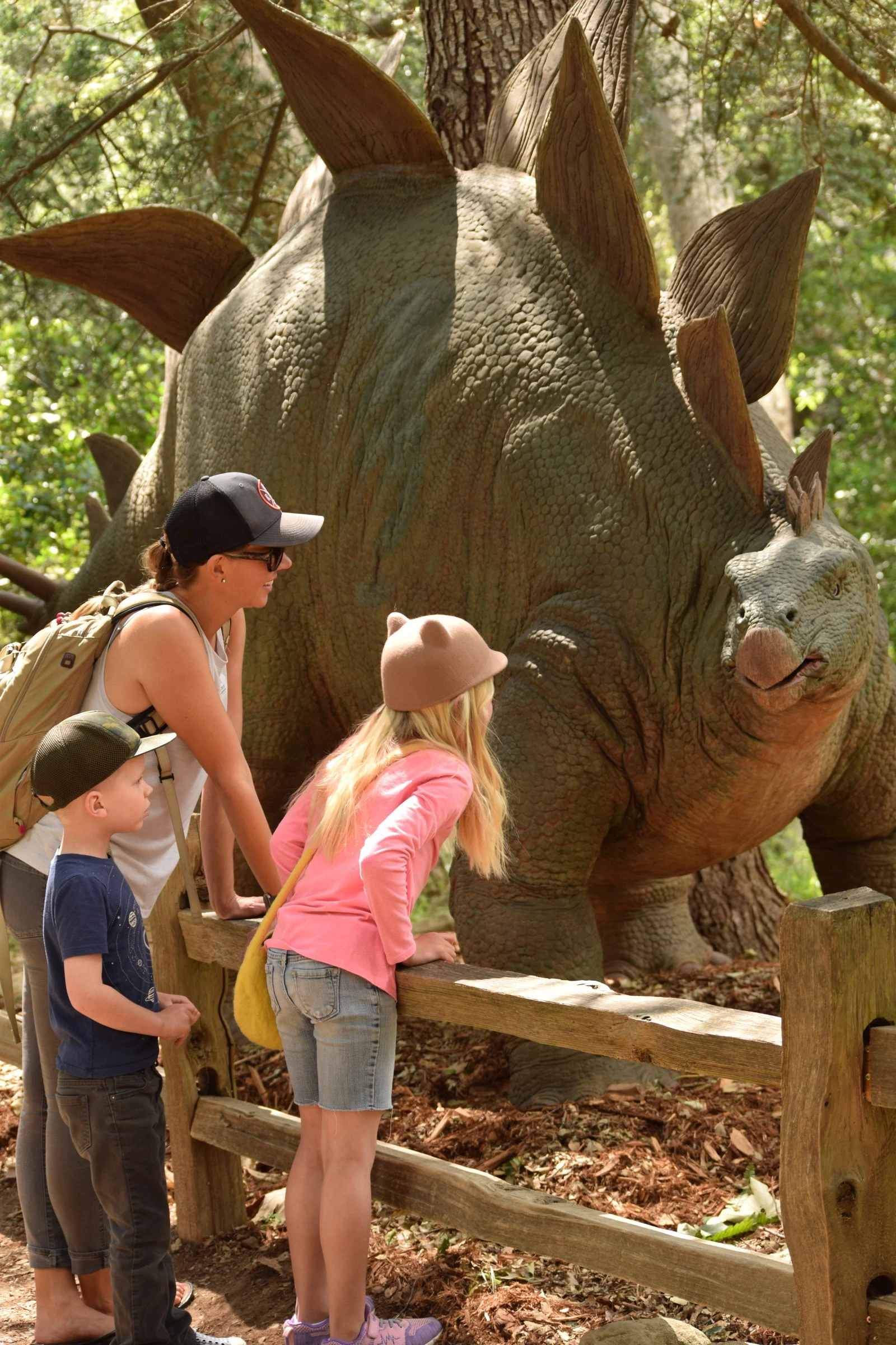 Kids taking a look at a stegosaurus statue at the Santa Barbara Museum of Natural History.