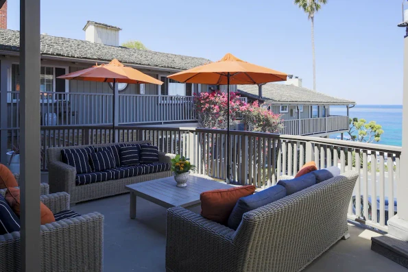 Outdoor seating on a balcony with ocean views at Scripps Inn La Jolla.