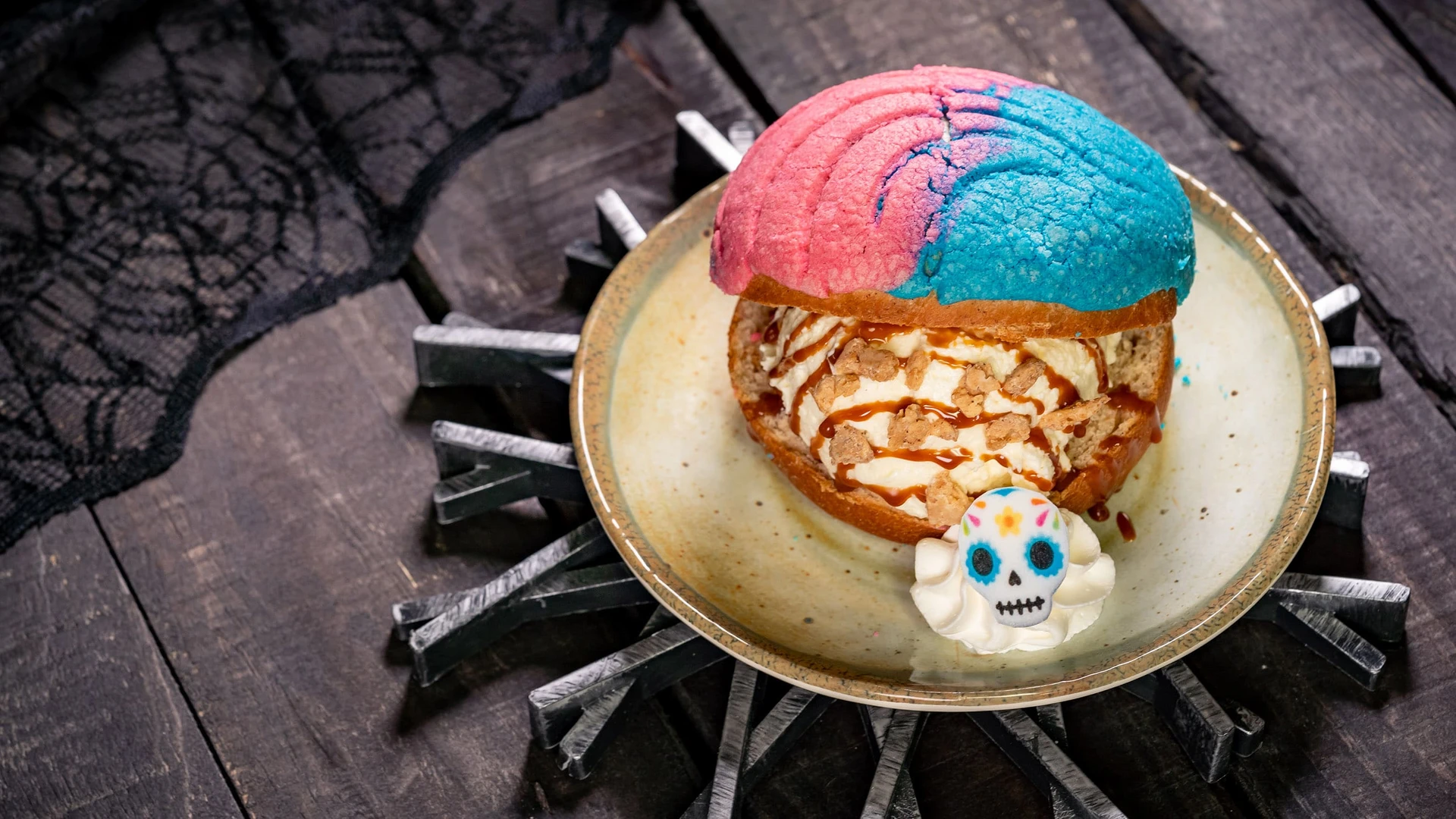 Pan Dulce Ice Cream sandwich on a place with a dollop of cream topped with a candy skull.