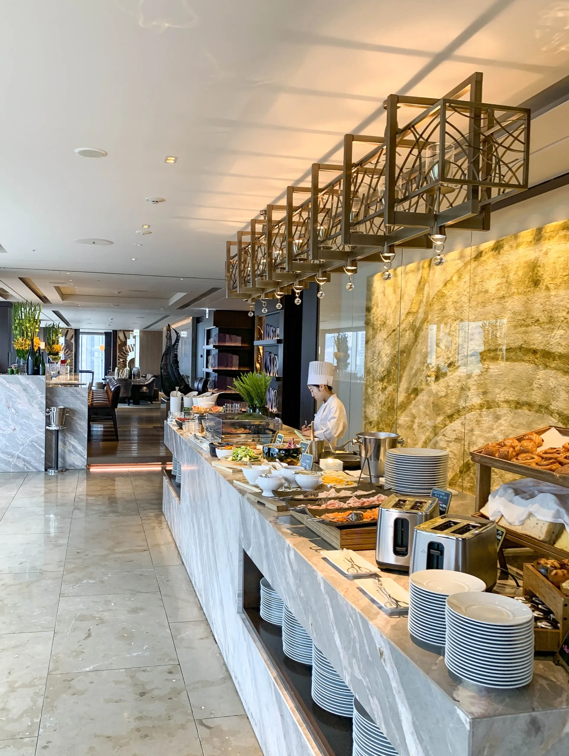 A chef prepares food at the Four Seasons Tokyo breakfast buffet.