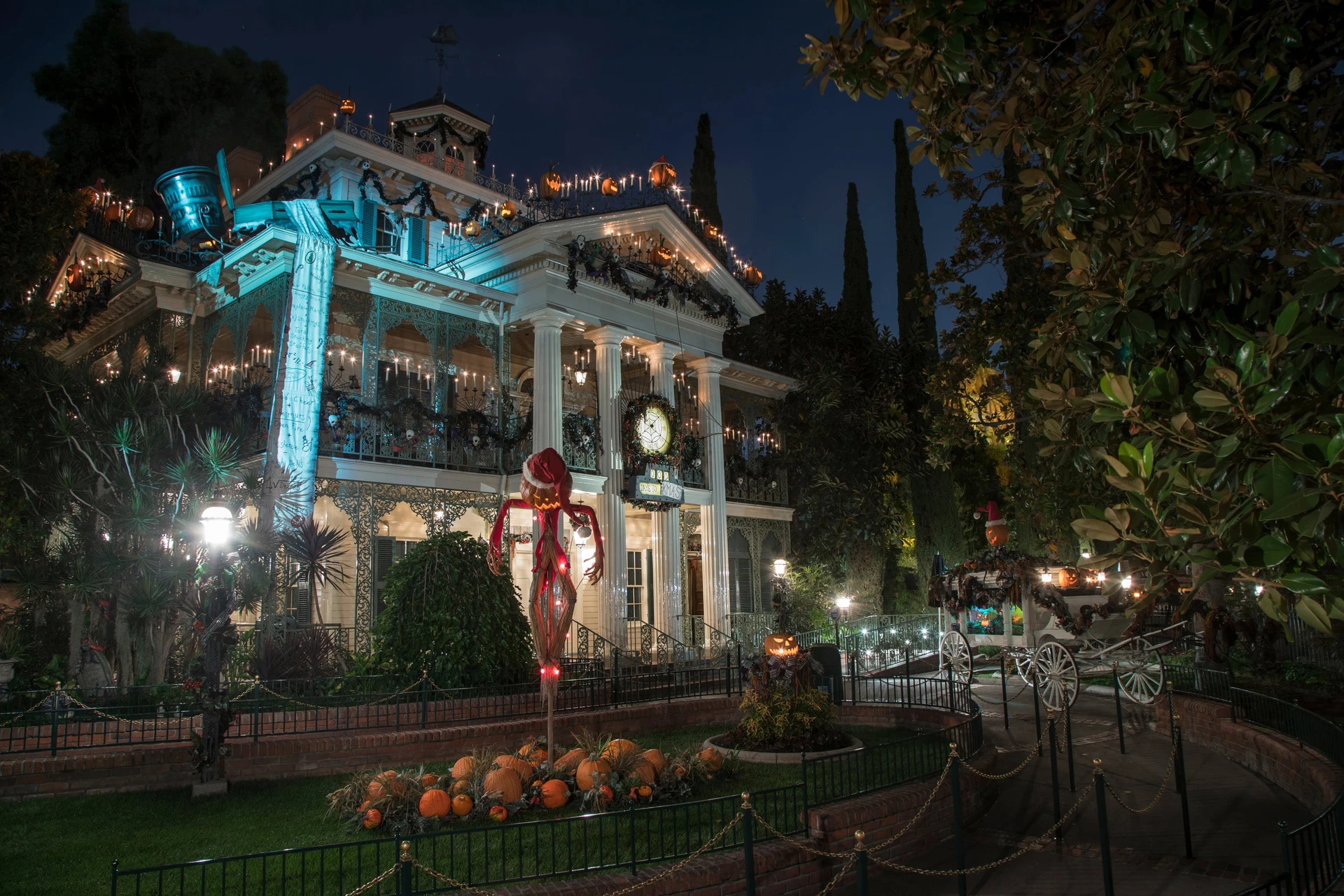 Jack Skellington poses in front of Haunted Mansion Holiday.