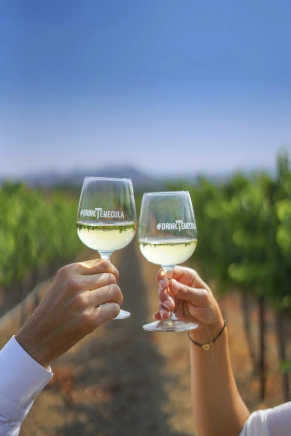 A couple cheers with white wine.