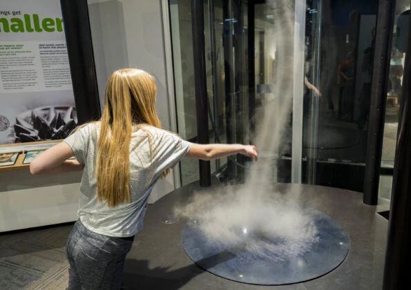 A child interacts with a hands-on exhibit at the Fleet Science Center.
