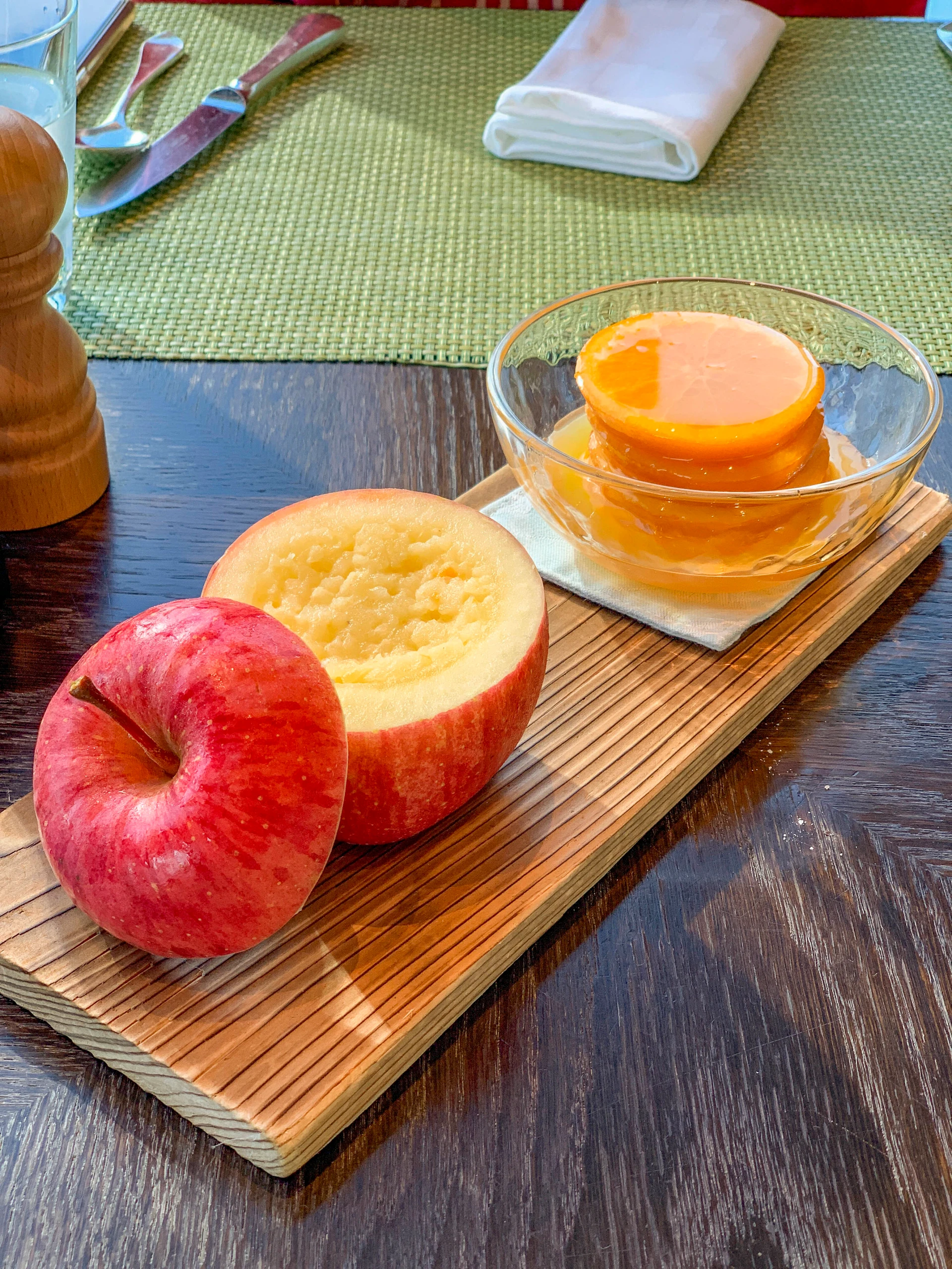 Complimentary apple compote and sweet oranges on a wood plank are given to guests at breakfast at Four Seasons Hotel Tokyo at Marunouchi.