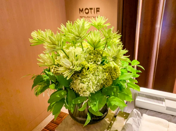 Green flower arrangement on the counter of Motif restaurant