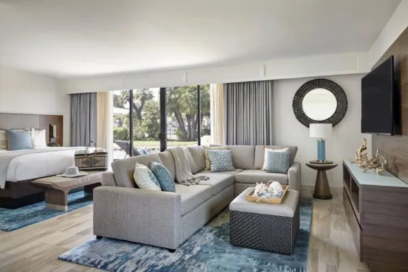 View of the L-shaped sofa to the bed in the one-room Junior Cottage at Coronado Island Marriott.