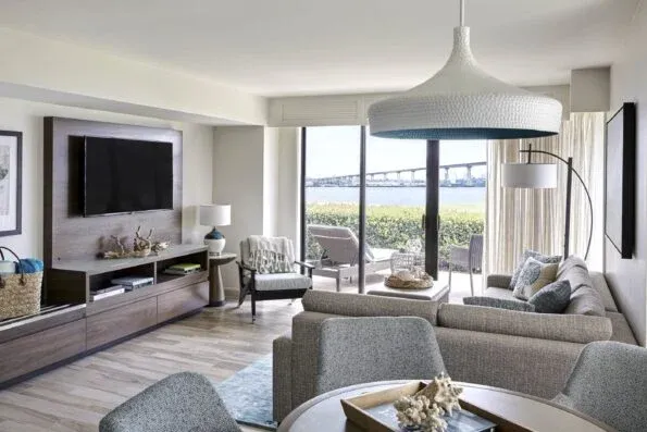 One bedroom cottage suite with living room and dining table overlooks the Coronado Bridge.