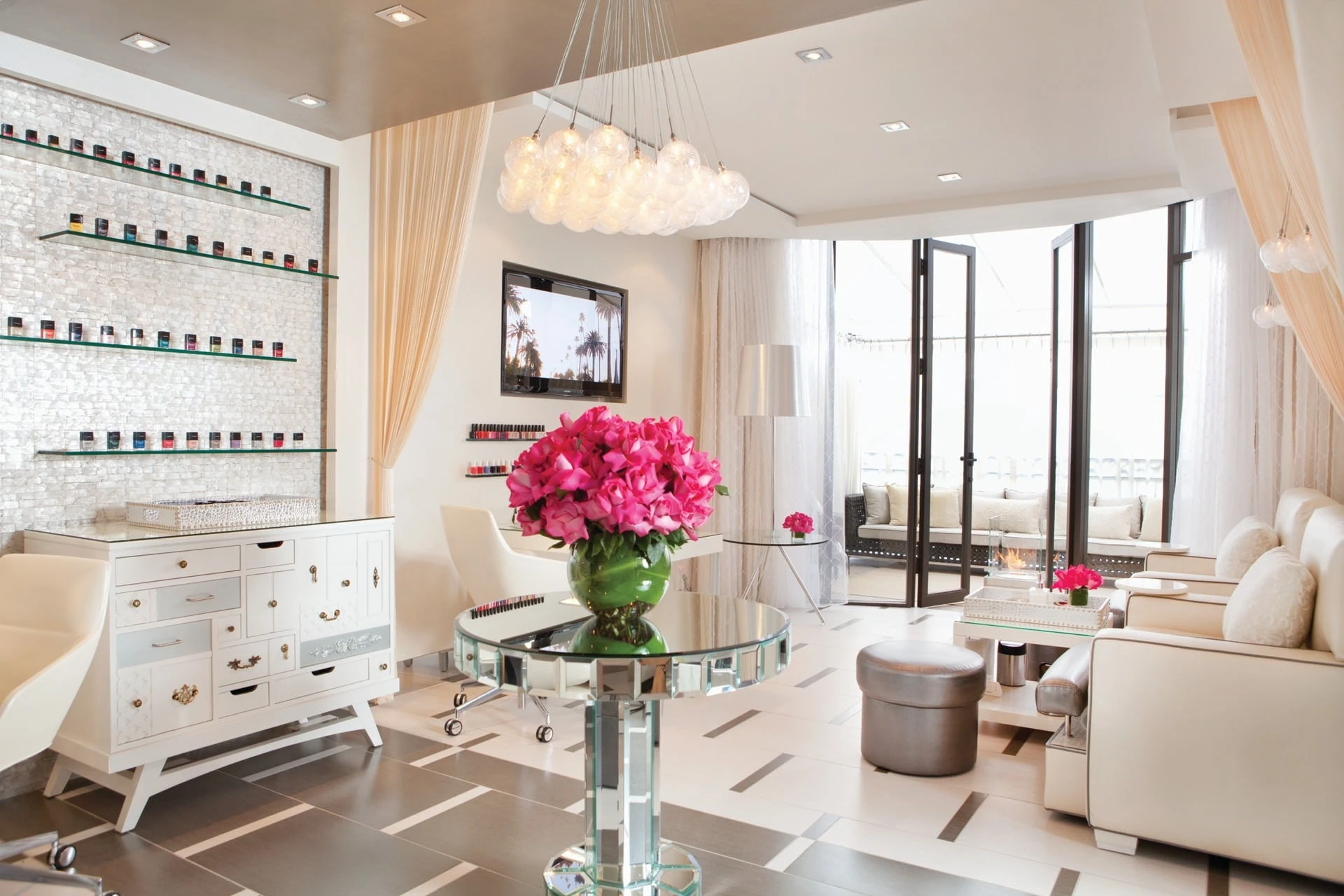 A view of the nail salon's white interior with shelves of polish