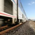 An Amtrak train passes by the Del Mar beach in San Diego at full speed