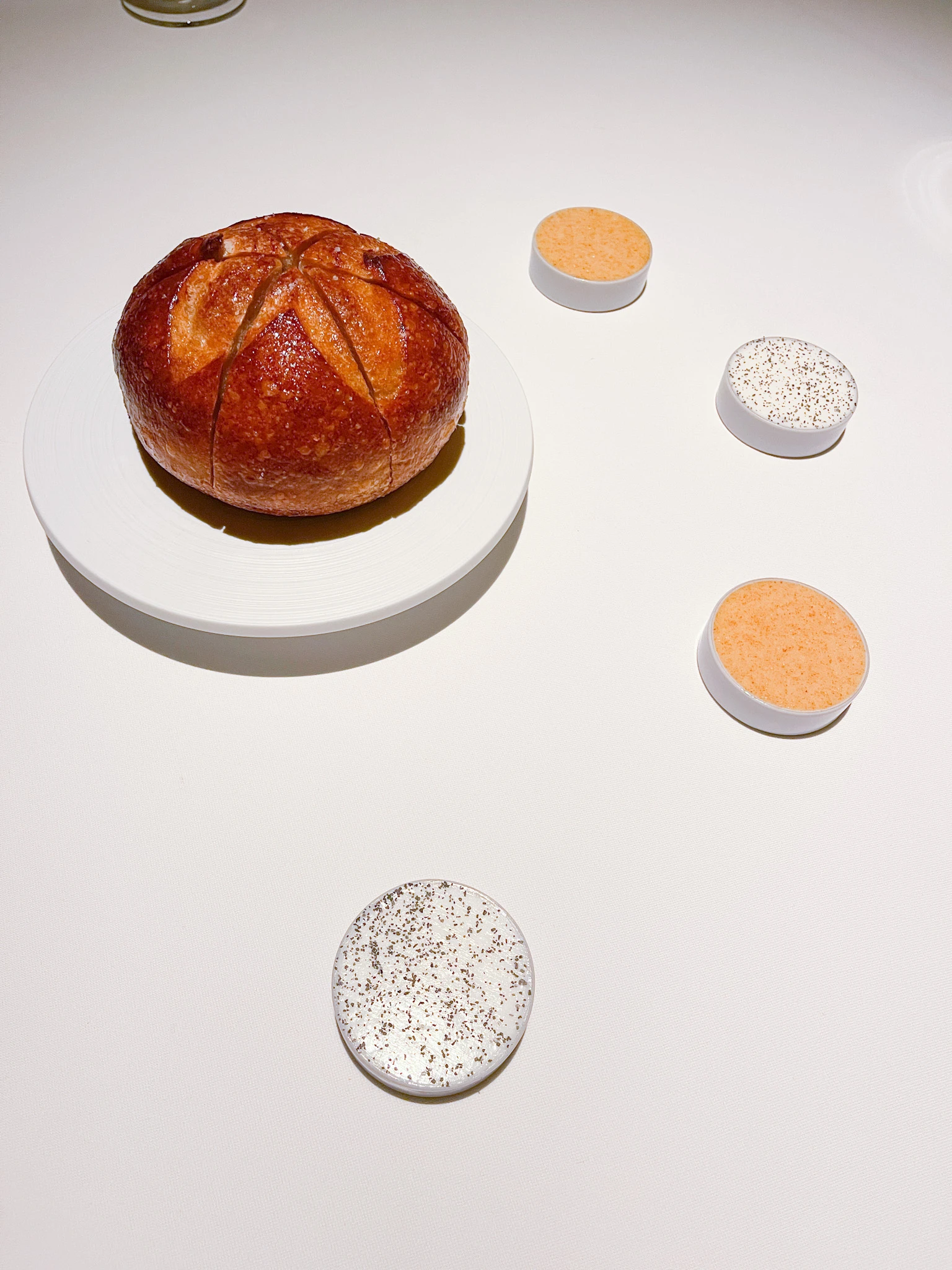 A delicious bread round with butters.