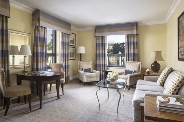 The Rodeo View Suite's living room with its contemporary neutral decor and hints of blue and yellow.