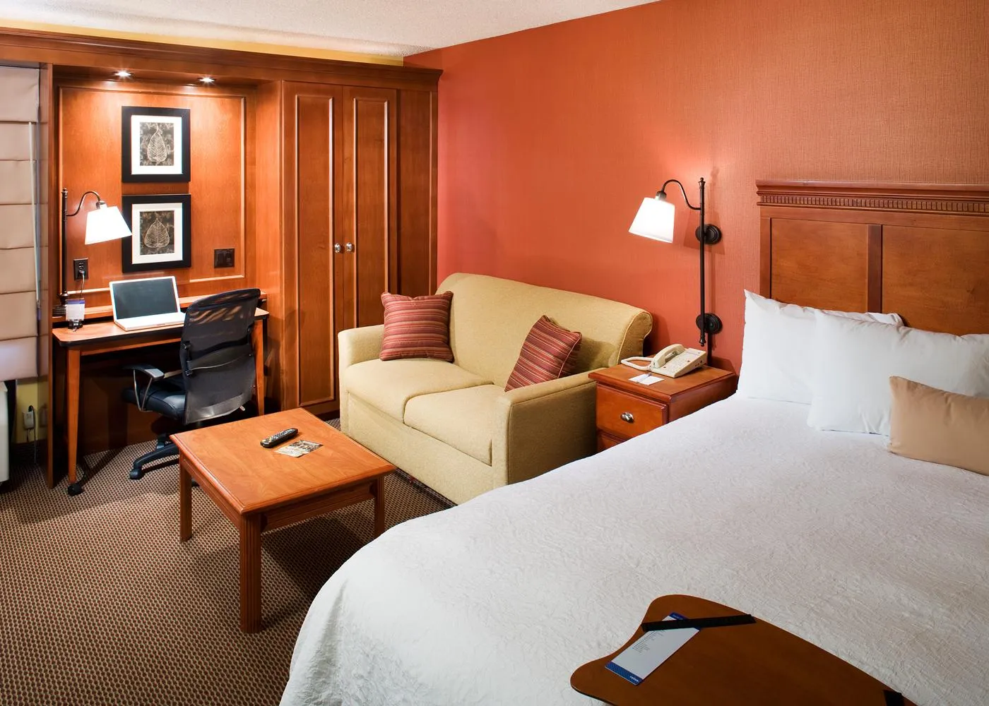 The interior of a room with orange and wood accents at Hampton Inn Santa Clarita.