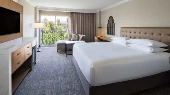 The contemporary interior with grey and neutral decor of a king room at Hyatt Regency Valencia.