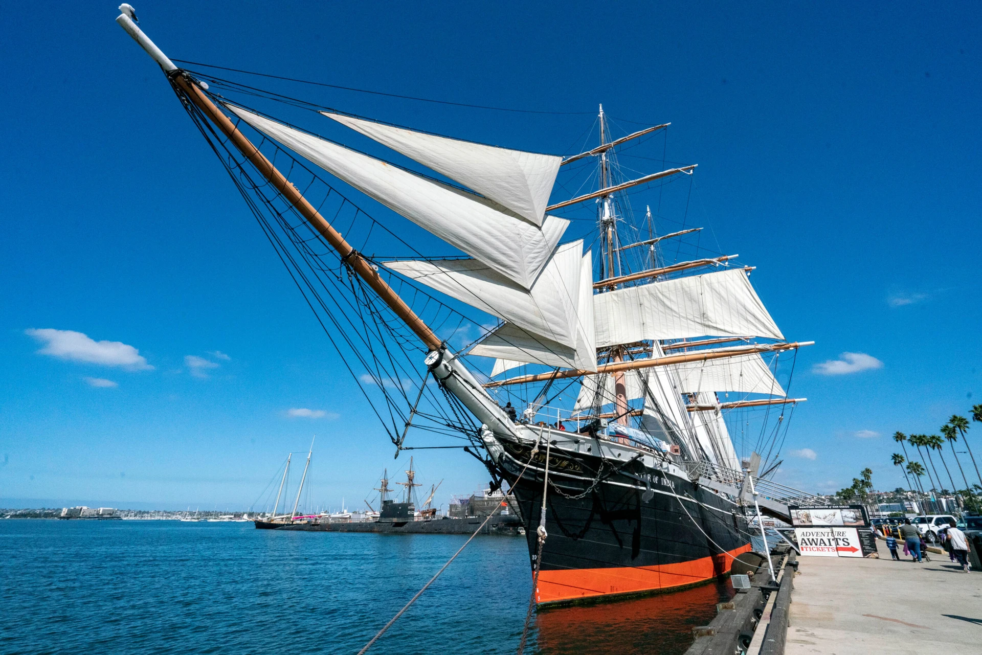 Star of India ship docked on the Embarcadero against a blue sky.