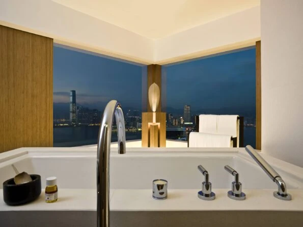 A view over the soaking tub out to the harbour at night.