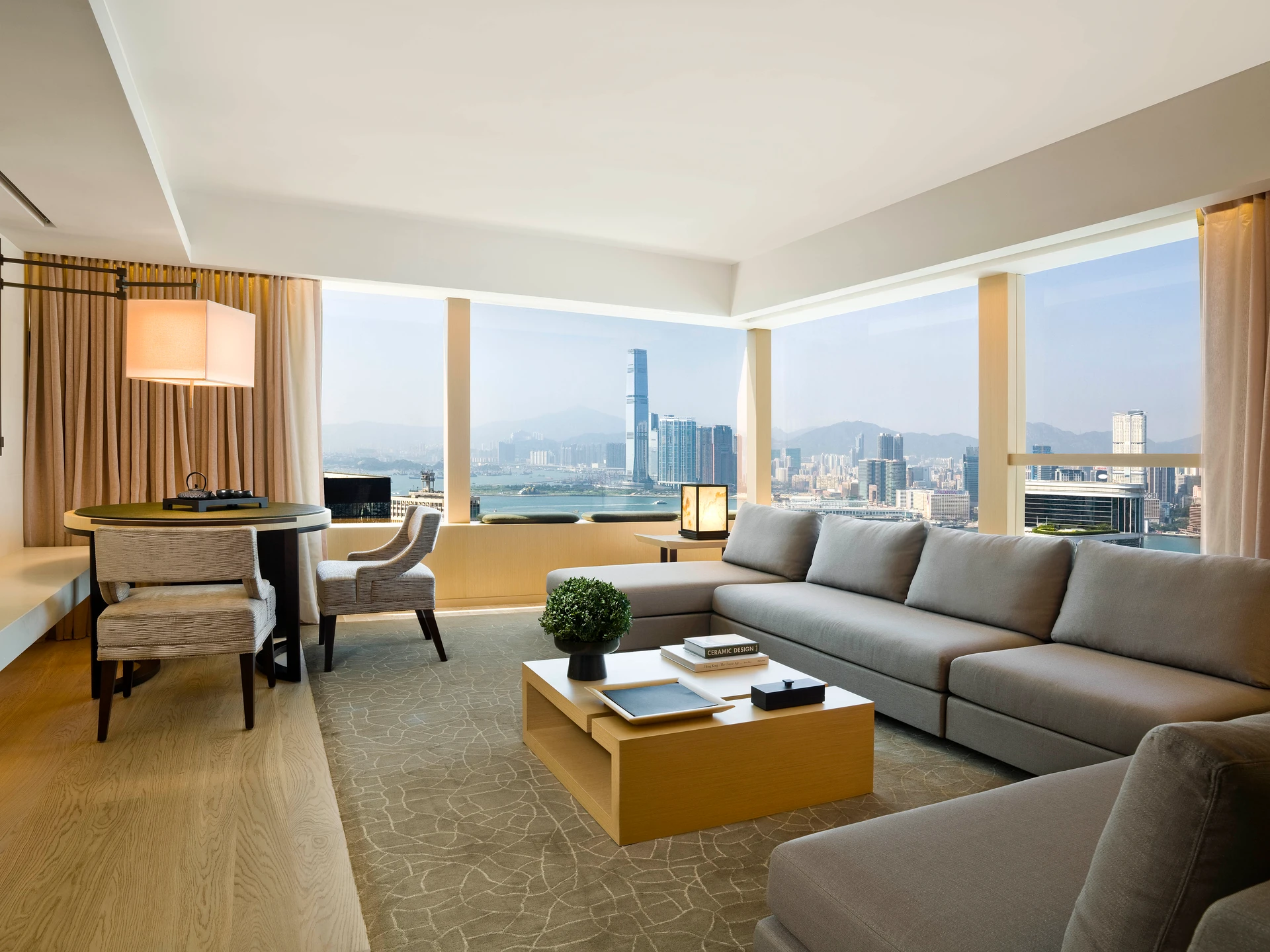 Long sofa against windows with a Victoria Harbour view.