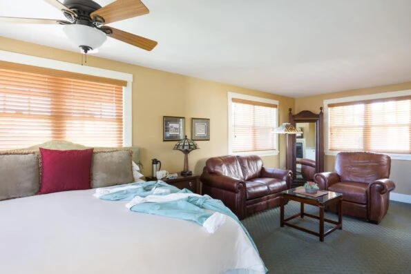 View over the bed to a seating area in the 1906 Lodge Coronado Garden King Polo Field room
