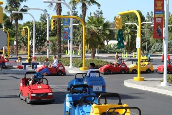 Kids drive LEGO cars around a track at LEGOLAND California.