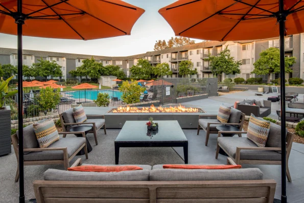 Restaurant seating and fire pit near the pool at Hilton Del Mar.