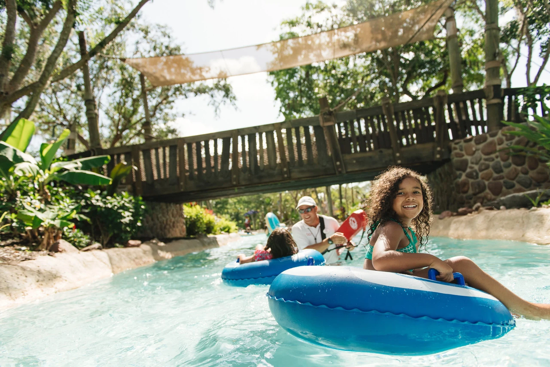 Two little girls float pass a lifeguard in the lazy river at Ketchakiddee Creek at Disney's