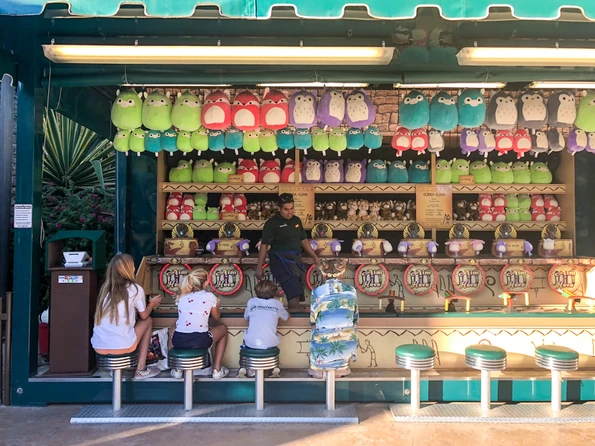 My daughter and her friends play carnival games at the theme park.
