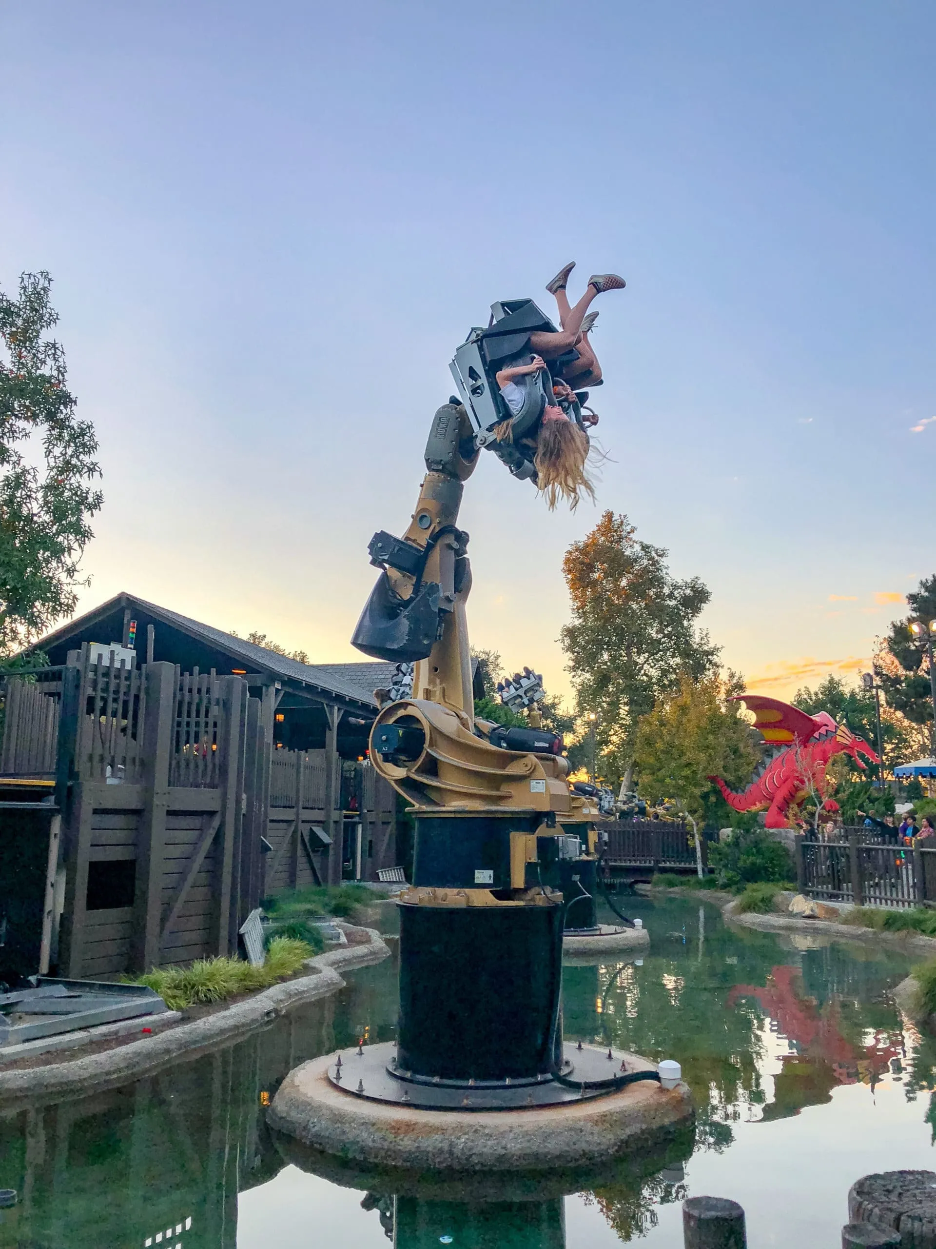 My daughter and her friend swing upside-down on Knights' Tournament.