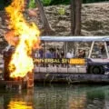 A World Famous Studio Tour Bus passes by fire during the tour.