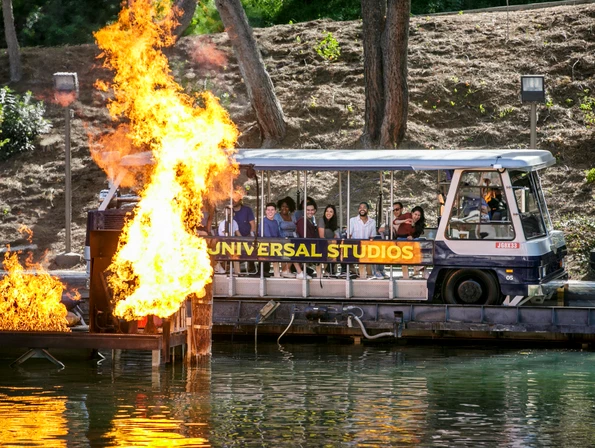 A World Famous Studio Tour Bus passes by fire during the tour.