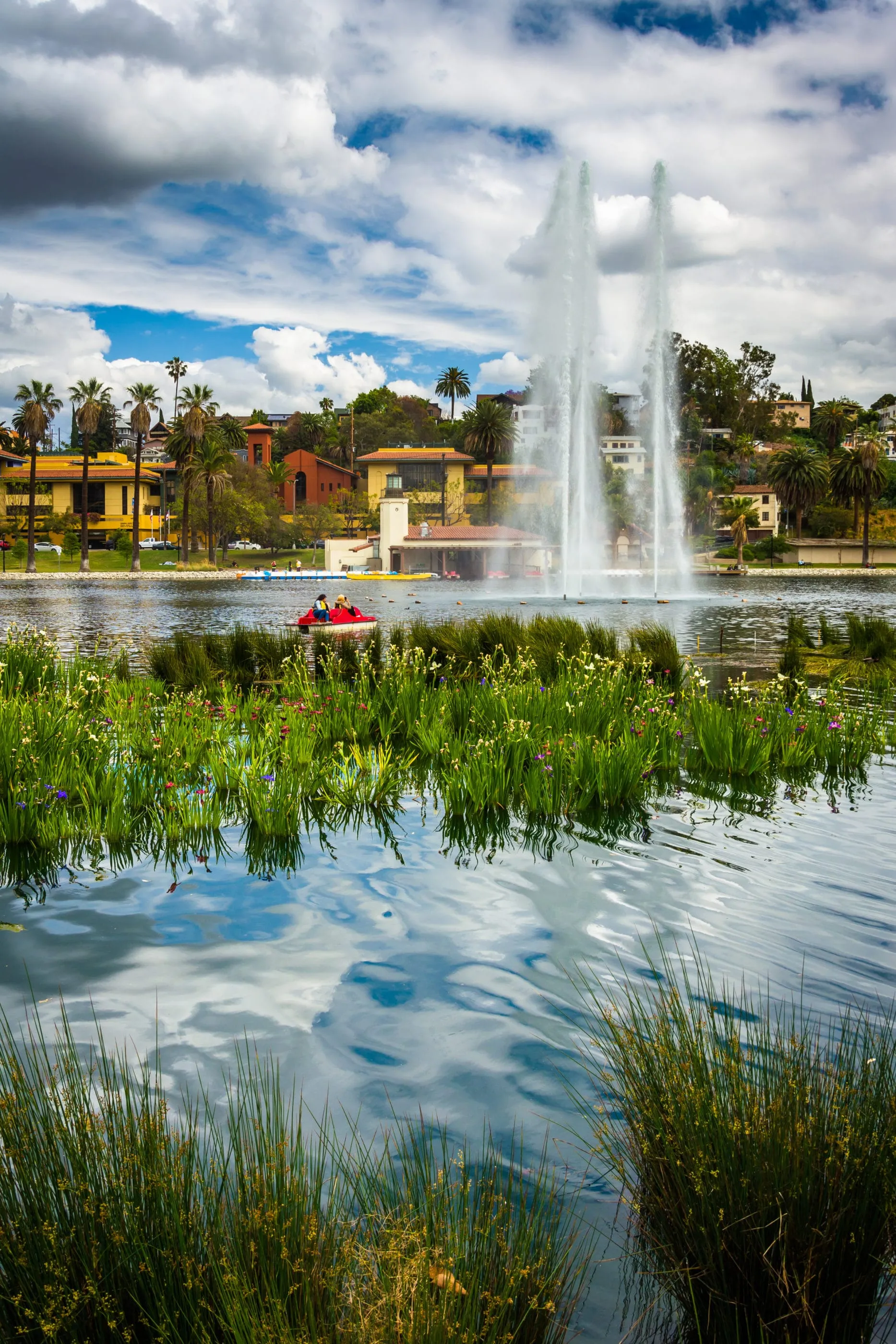 A red paddle boat out in the middle of Echo Park Lake in Los Angeles