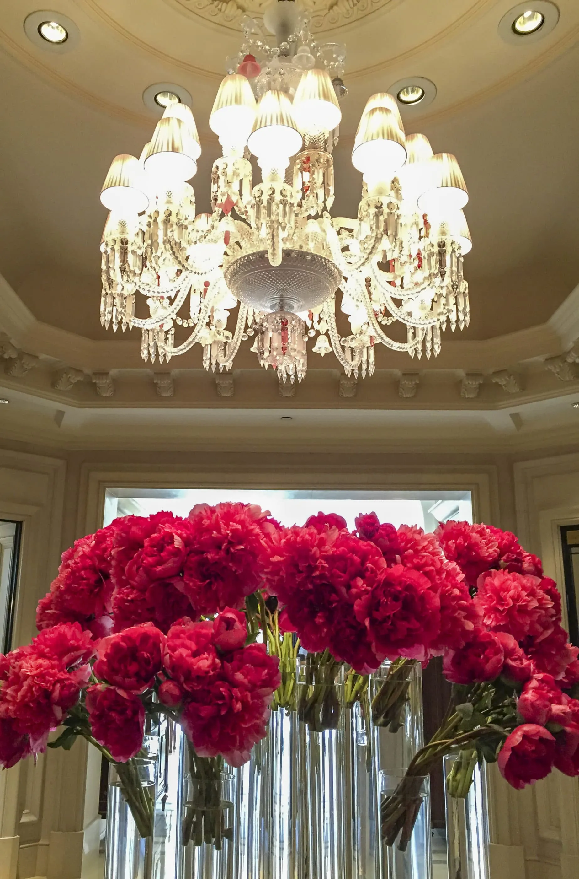 Large peonies under a chandelier at Four Seasons Paris.