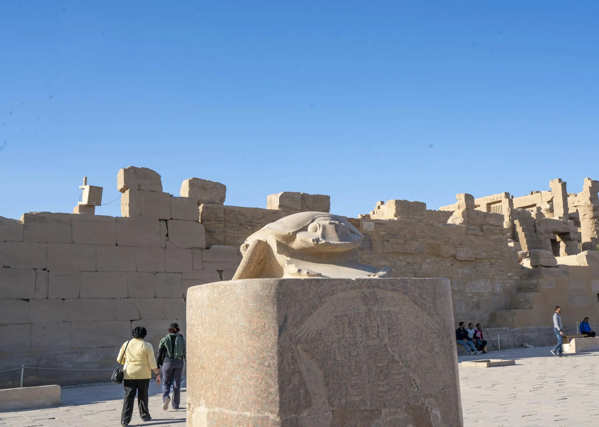 The scrub statue sits on a pedestal at Karnak Temple in Luxor Egypt.