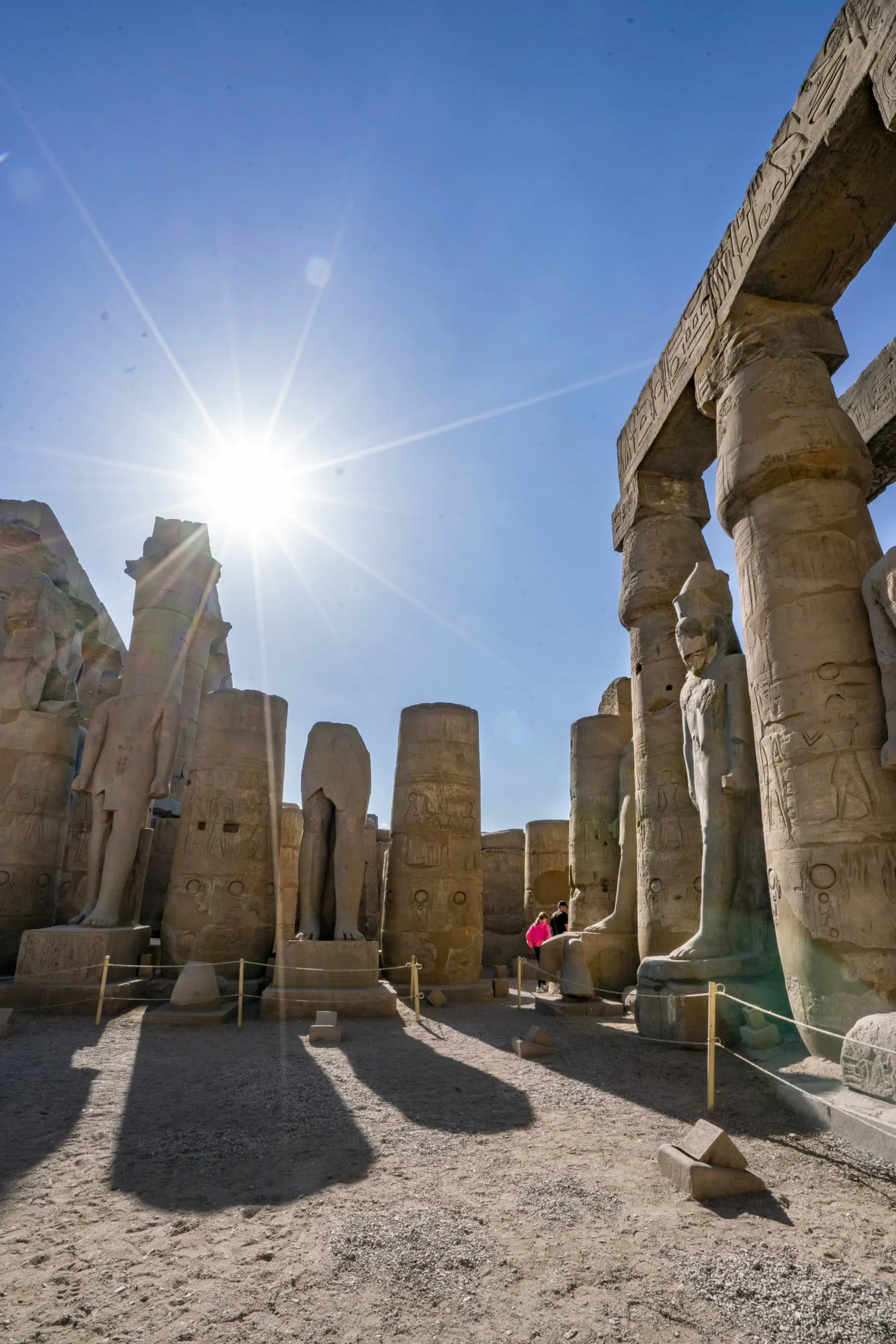 Walking through the statues inside Luxor Temple with our guide.