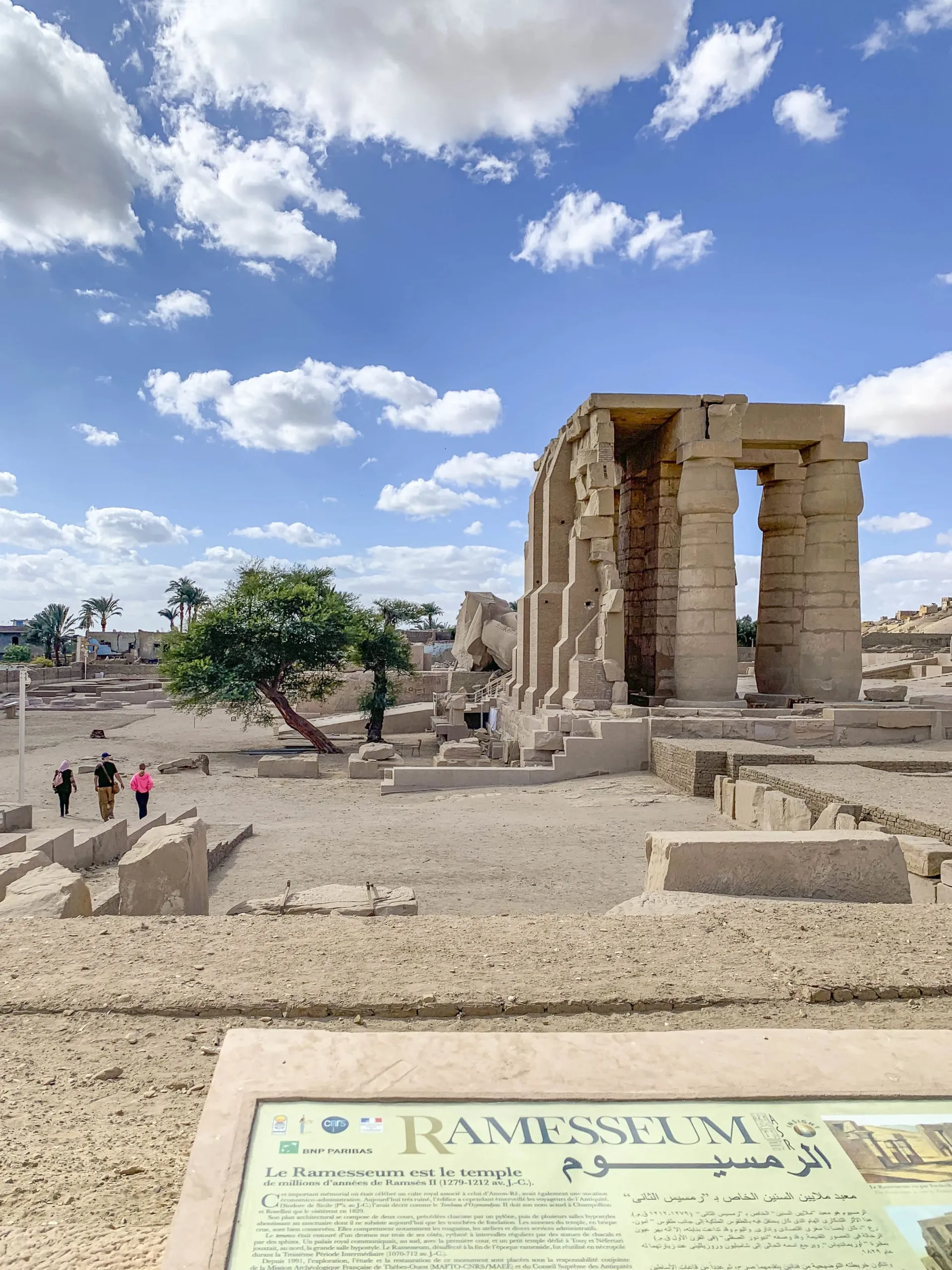 Ruins of the Rammeseum in Luxor stand tall and near the toppled over statue of Ramses II.