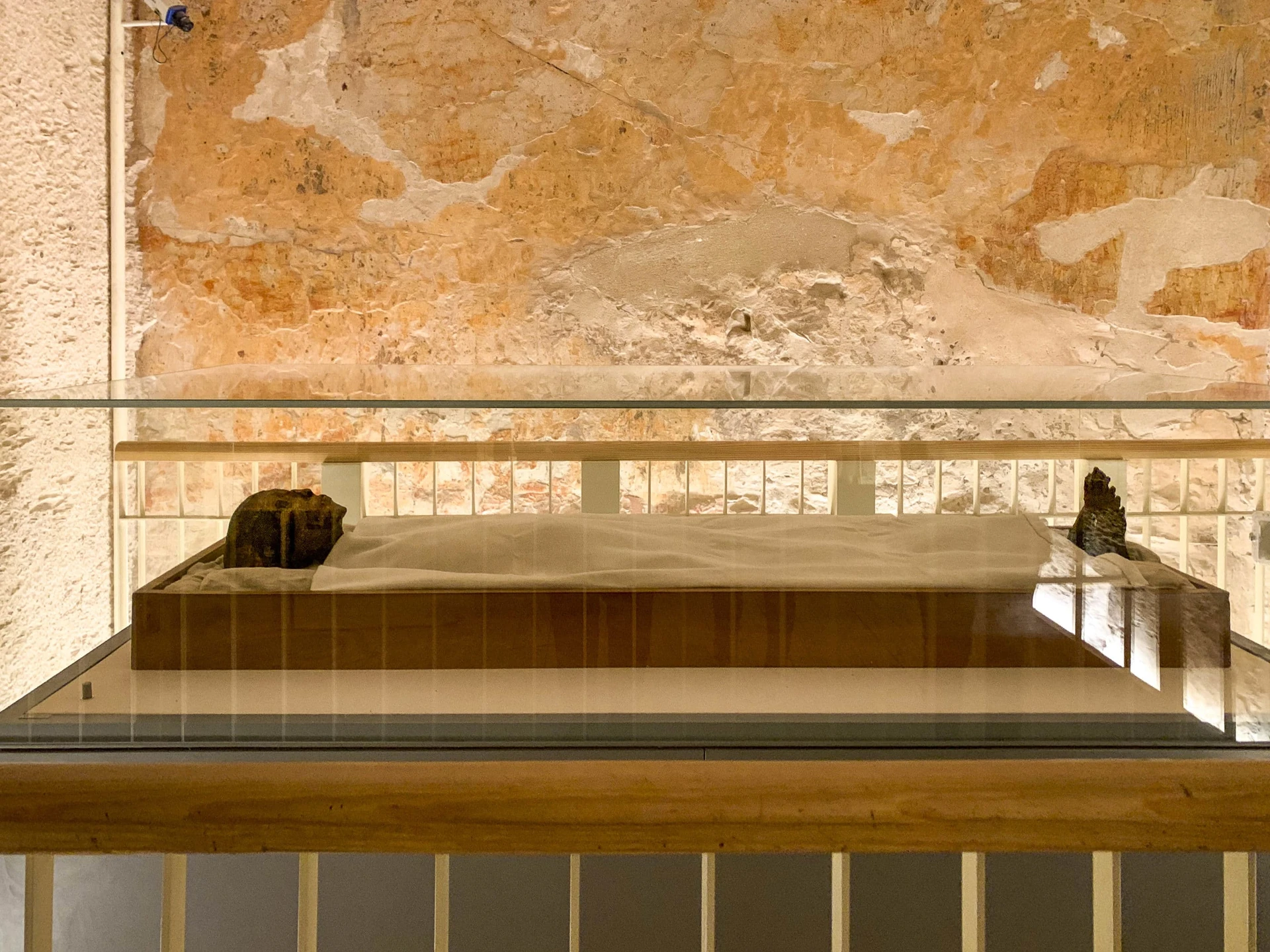 King Tut's mummy on display under glass inside his Valley of the Kings tomb.