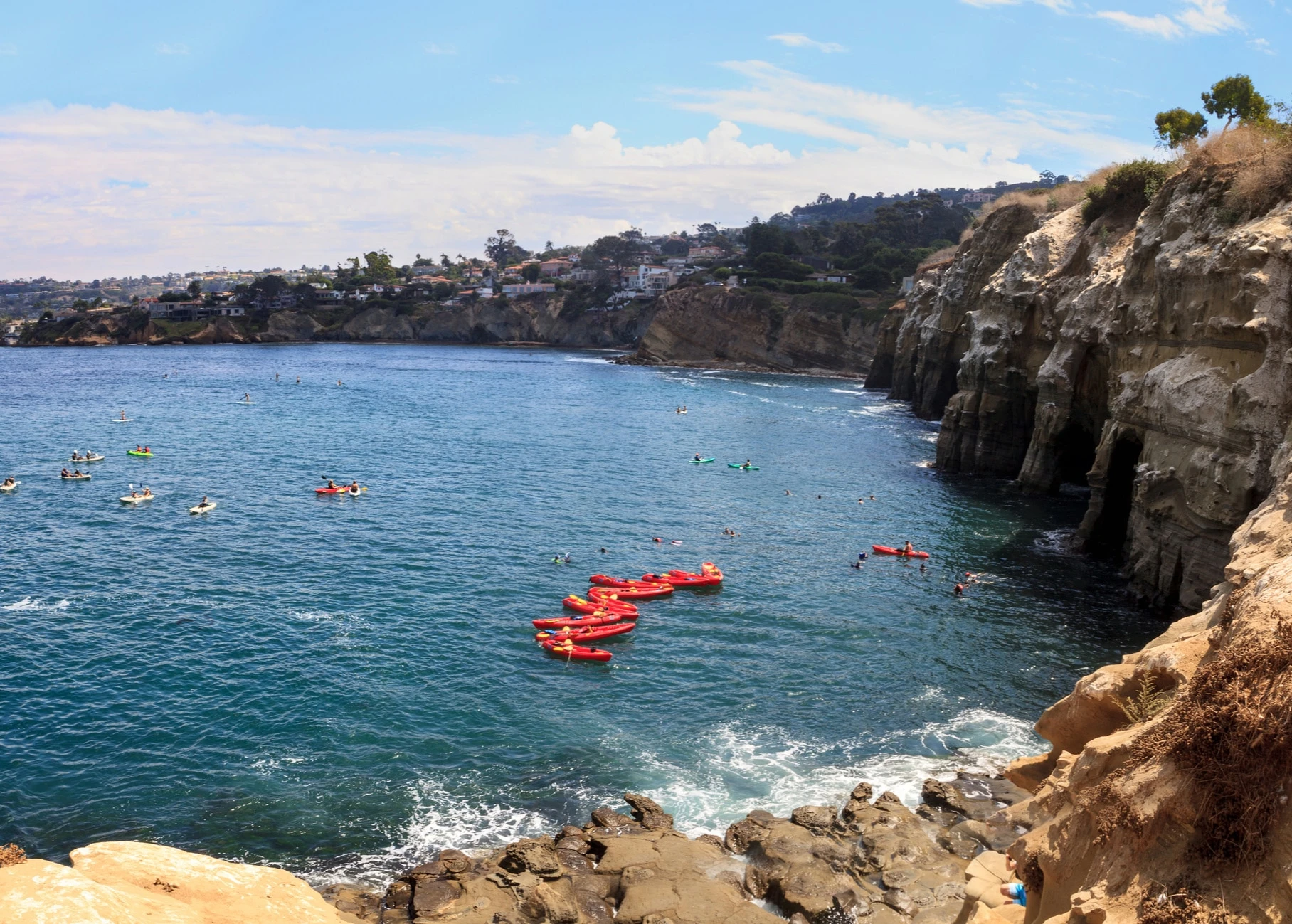 Kayaks near coastal caves at La Jolla Cove in Southern California in summer on a sunny day