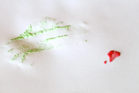 Testing the green cold water finger paint and the red Kool Aid finger paint &mdash; the latter spreads better.