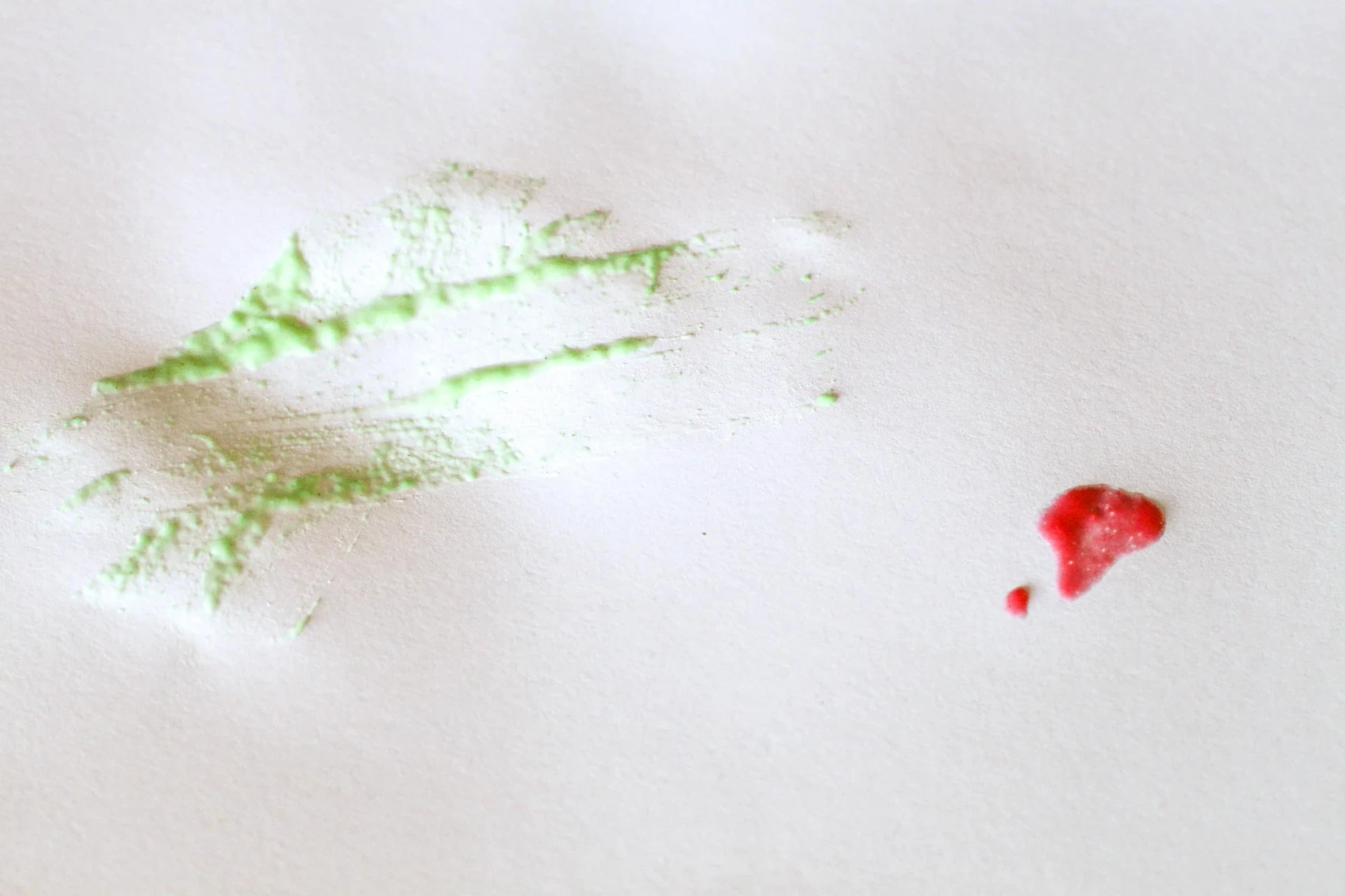 Testing the green cold water finger paint and the red Kool Aid finger paint &mdash; the latter spreads better.