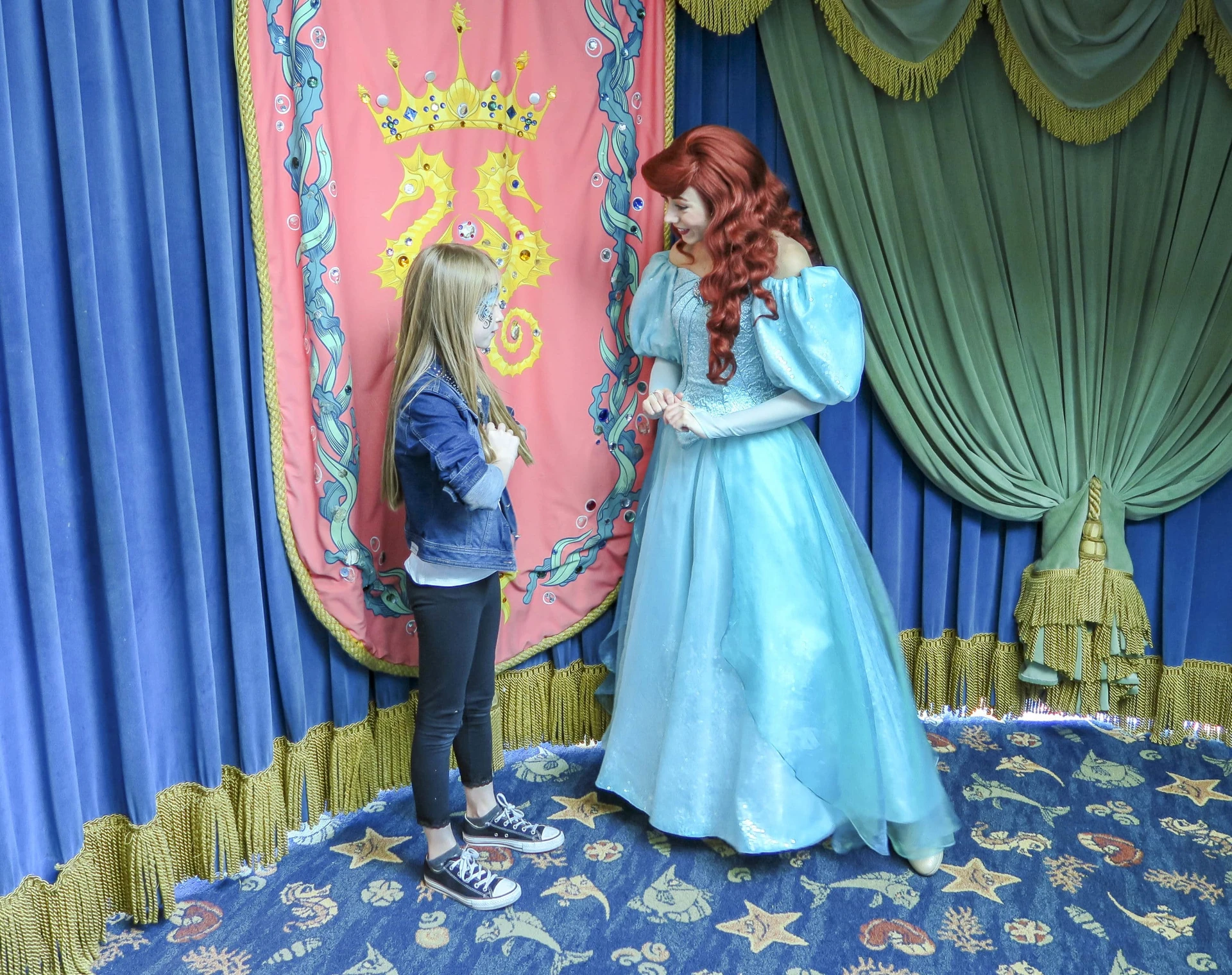 My daughter greets Princess Ariel. I'd forgotten her autograph book so do remember to bring yours to avoid purchasing one at the park.