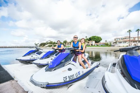 A family prepares to ride a waverunner in Mission Bay at the water sports center in front of the resort.