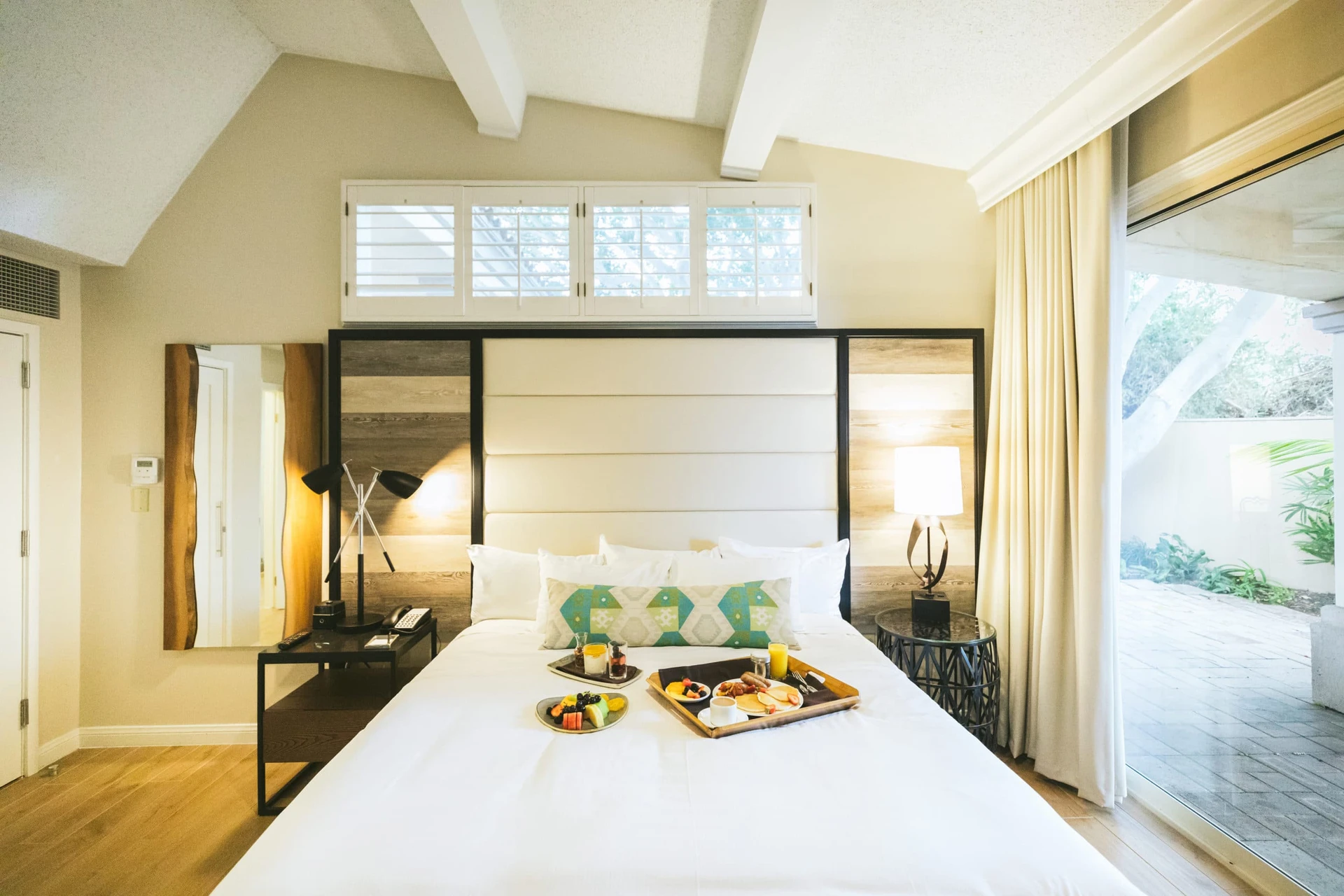 A renovated king room interior (neutral, white, coastal decor) at San Diego Mission Bay Resort.