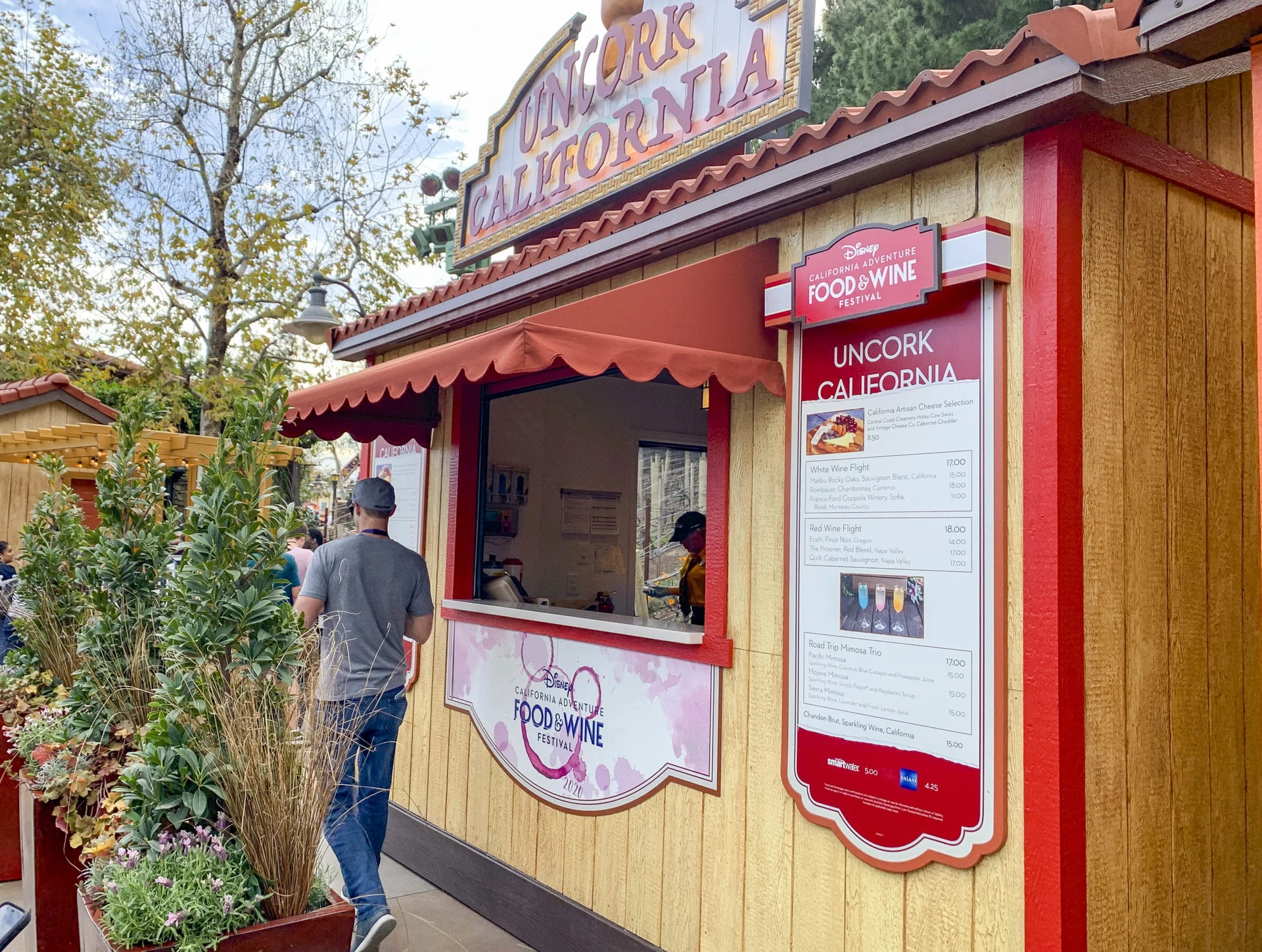 The a man walks by the Uncork California Marketplace at Disney California Adventure.