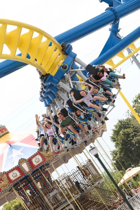 Families hang in seats on a roller coaster track at Fun Spot America i Orlando.
