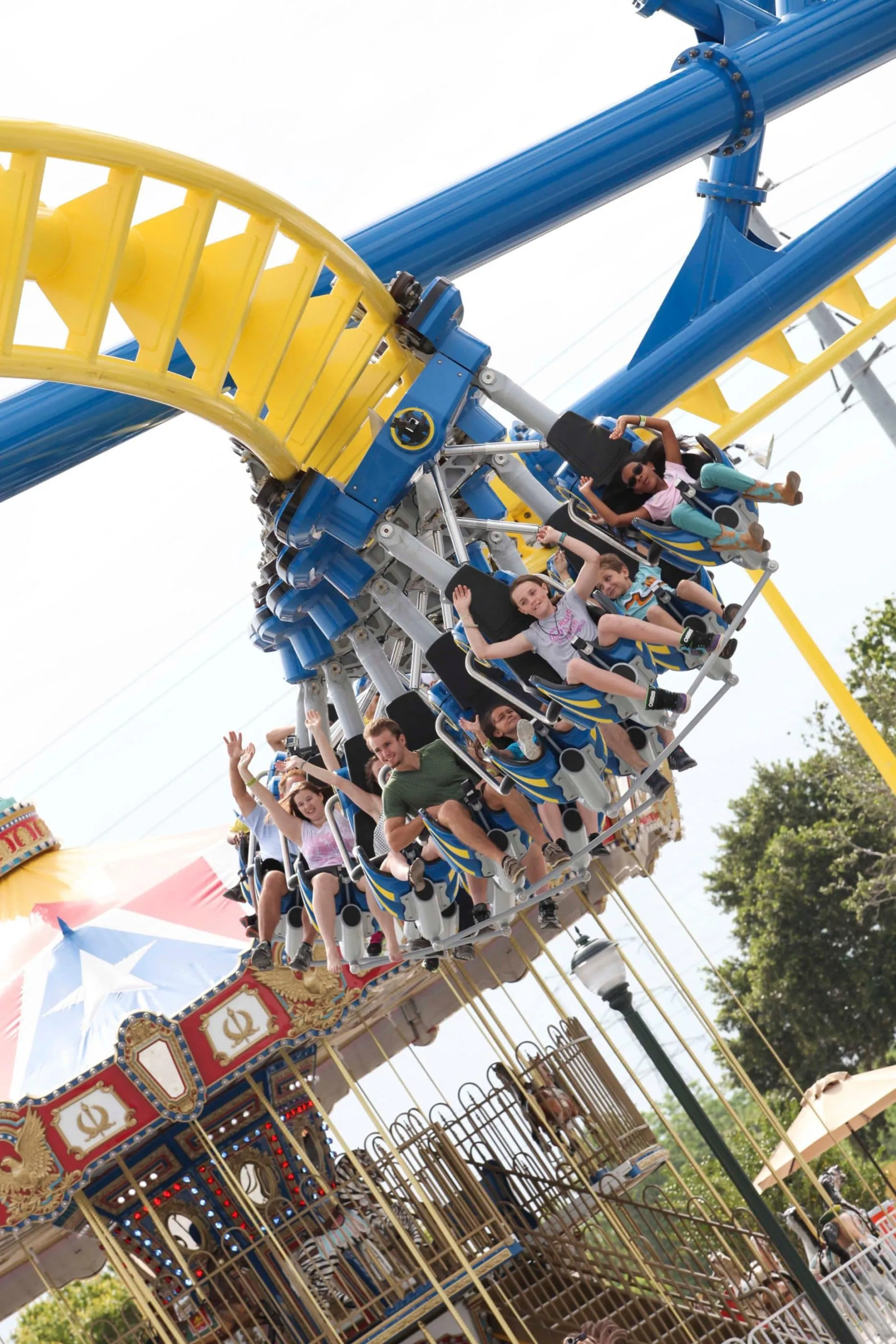 Families hang in seats on a roller coaster track at Fun Spot America i Orlando.