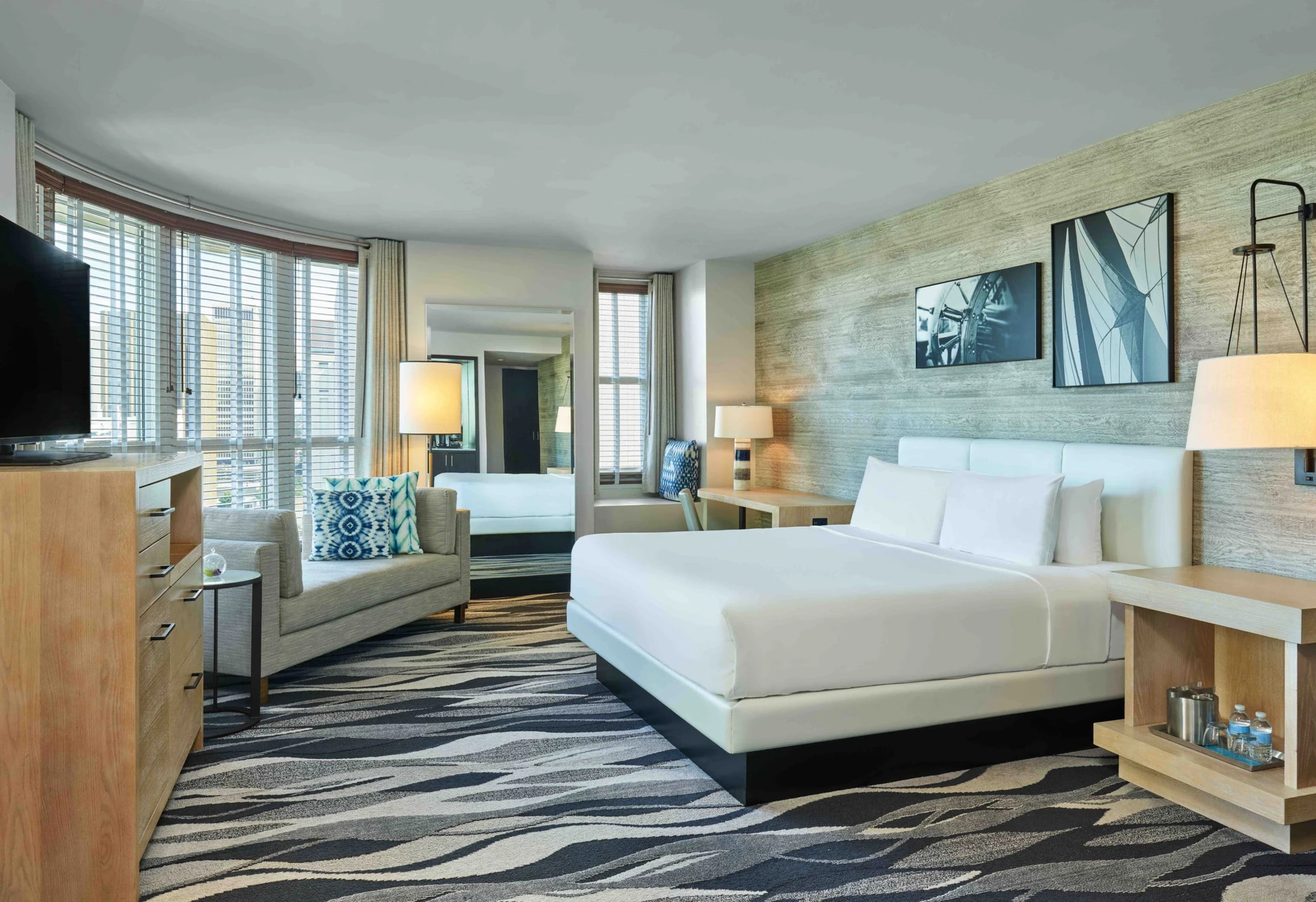 Coastal contemporary king room decorated in gray, whites, and blues at Hotel Republic San Diego.