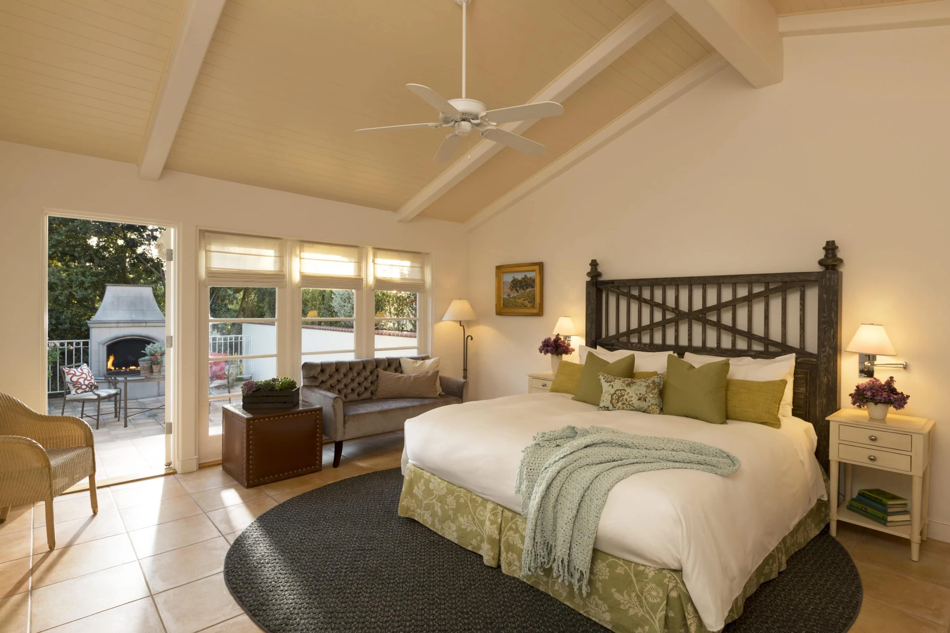 A gorgeous king room with an outdoor patio fireplace at The Inn at Rancho Santa Fe