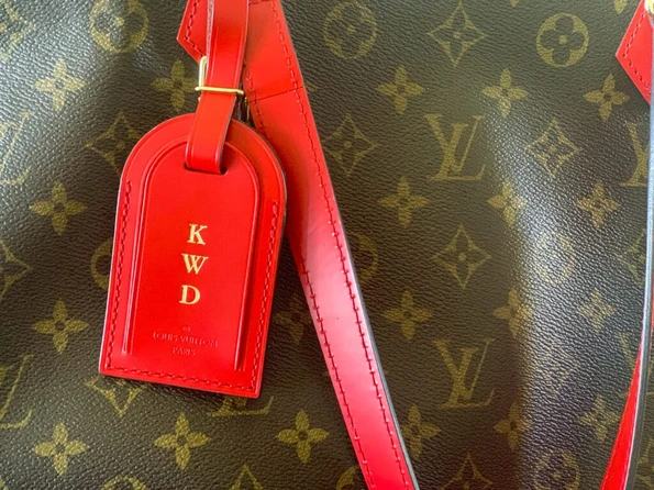 A hot stamped luggage tag on my All-In Louis Vuitton handbag.