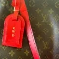 A hot stamped luggage tag on my All-In Louis Vuitton handbag.