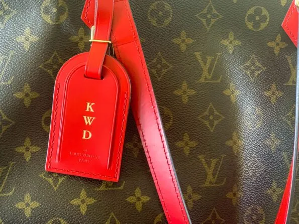 A hot stamped luggage tag on my All-In Louis Vuitton handbag.